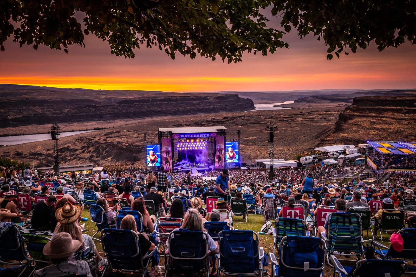 Spectacular sunset concert at The Gorge Amphitheatre near Sagecliffe Residences by Naakef, with thousands of attendees enjoying live music against the dramatic Columbia River backdrop.