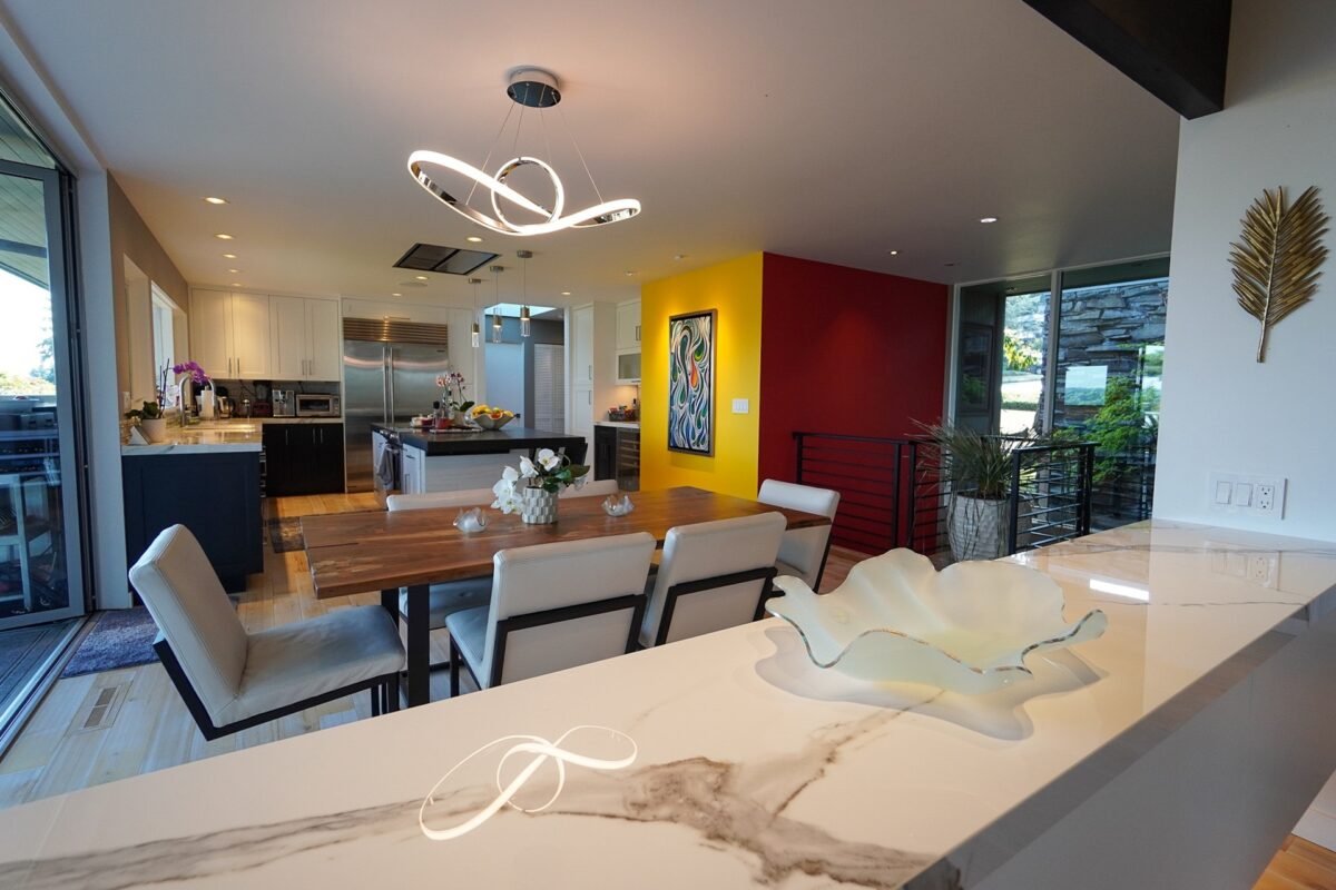 Fully equipped modern kitchen featuring a wine fridge, white cabinetry, and yellow accent wall at Naakef Travel Nurse Stay – Lake Forest Park.