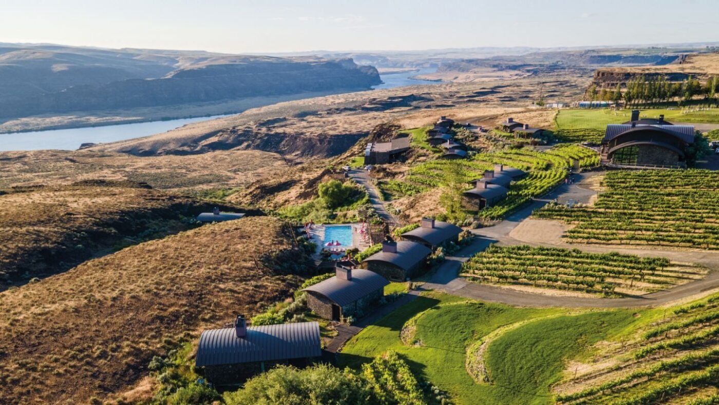 Comprehensive aerial view of Sagecliffe Residences by Naakef showcasing the pool, vineyards, stone cabins, main lodge, and spectacular Columbia River Gorge panorama.