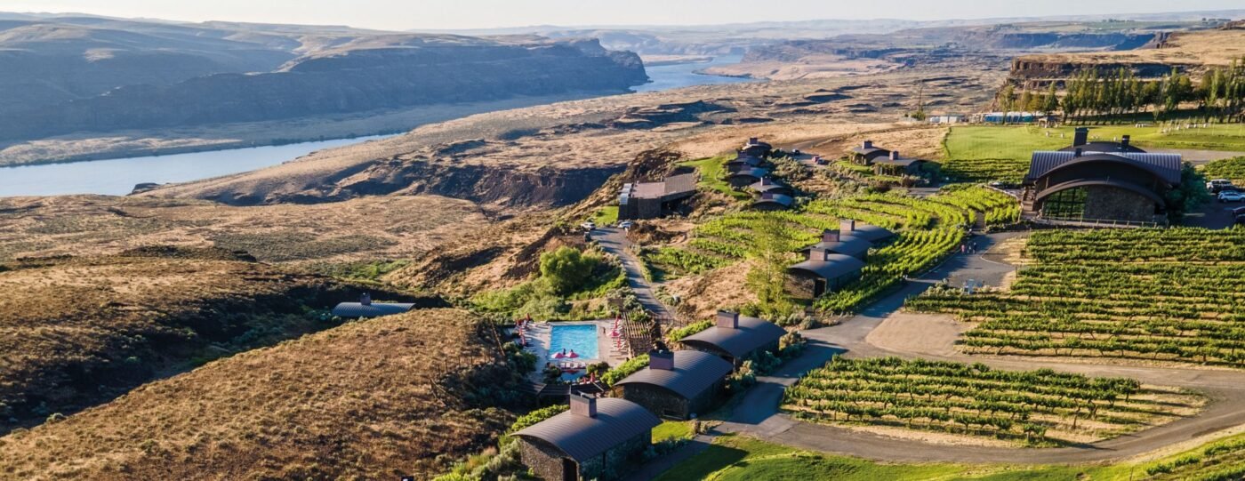 Spectacular aerial overview of Sagecliffe Residences by Naakef, featuring the resort buildings, swimming pool, and lush vineyards overlooking the river gorge.