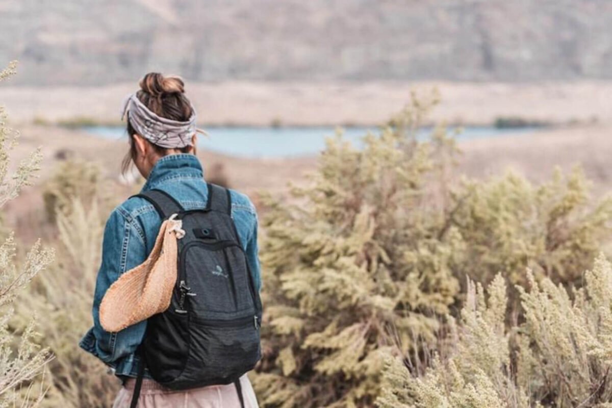 Hiker with backpack on a scenic trail overlooking the Columbia River Gorge landscape at Sagecliffe Residences by Naakef.